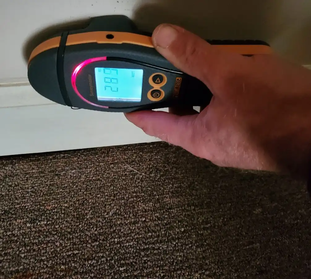Moisture detection at baseboard during Storm Damage Restoration in Guttenberg